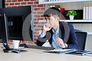 Young asian office man struggle with computer, Frustrated asian business man looking at computer while working at office, Business