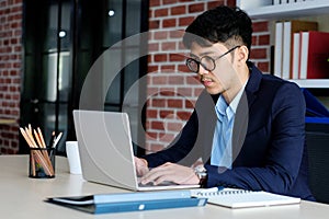 Young asian office man struggle with computer, Frustrated asian business man looking at computer while working at office, Business