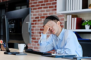 Young asian office man struggle with computer, Frustrated asian business man looking at computer while working at office, Business