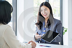 Young Asian officer woman hand holding a credit card, for spending pay online shopping according to discount products