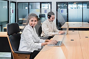 Young asian operator woman agent with headsets working customer service in a call center