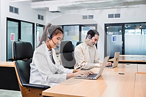 Young asian operator woman agent with headsets working customer service in a call center