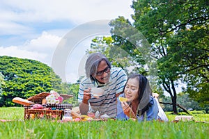 Young Asian in park. they are having a picnic and relax time.