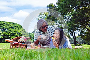 Young Asian in park. they are having a picnic and relax time.