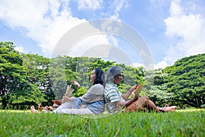 Young Asian in park. they are having a picnic and relax time.