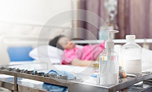 Patient illness has medical tool cart beside her photo