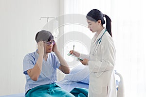 Young Asian patient man meeting the doctor, getting headache, depression problem