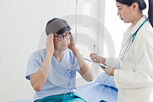 Young Asian patient man meeting the doctor, getting headache, depression problem
