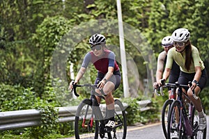 young asian people cycling on rural road