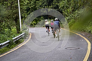 young asian people cycling on rural road