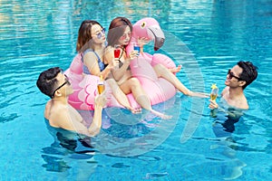 Young Asian people having fun together in the pool