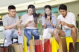 Young asian people playing with mobile phones