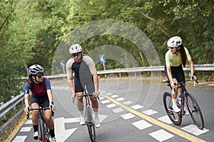 Young Asian people riding bicycle outdoors