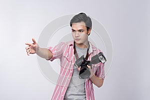 Young asian photographer holding digital camera, while working i