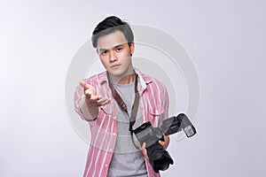 Young asian photographer holding digital camera, while working i
