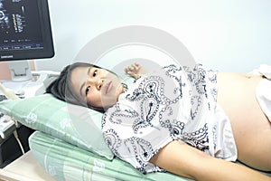 Young asian pregnant woman preparing herself for giving birth in hospital