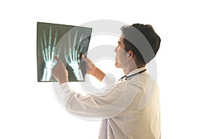 Young Asian radiologist In a doctor`s suit look at the x-ray image of the lumen of the bone on a white background.