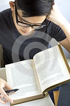 Young asian reading text