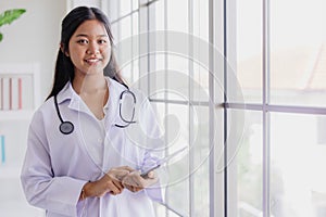 Young Asian roleplay as doctor standing happy smiling in school lab with space for text photo