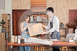 Young asian sales man gives shopping bag with purchased merchandise and clothes to woman customer, Beautiful female buying dress