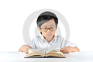 Young Asian schoolboy reading book