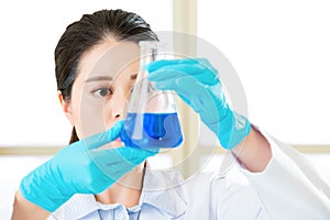 Young asian scientist pipetting in life science laboratory