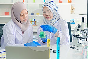 Young Asian scientist with test tube making research in clinical laboratory,Science