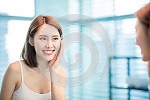 Woman use oil blotting paper photo