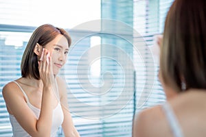 Woman use oil blotting paper photo