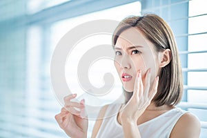 Woman use oil blotting paper photo