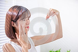 Woman use oil blotting paper photo