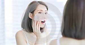 Woman use oil blotting paper photo