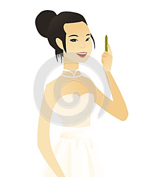 Young asian smiling fiancee with pen.