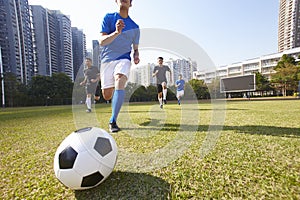 Asian soccer football players chasing the ball