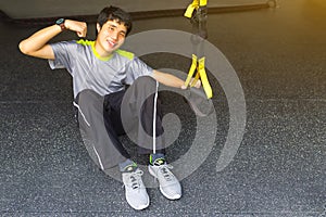 Young asian strong man holding lifeline pull up revolution getting ready for exercise in fitness.