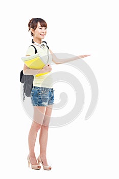 Young Asian student girl pointing side space