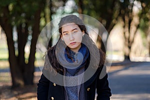 Young asian student on sunny day in park.