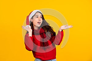 Young Asian surprised and shocked. Asian woman wear Santa Claus Christmas red hat spread hands