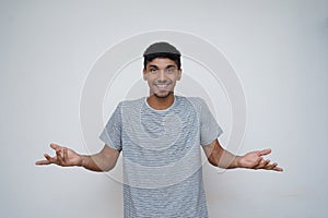 Young asian teen boy confused expression with a smile showing to the camera with white background