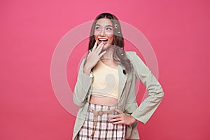 Young Asian teenage girl surprised excited isolated on pink background