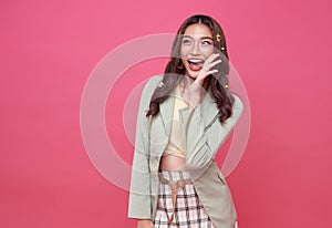 Young Asian teenage girl surprised excited isolated on pink background