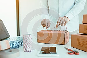 Young asian teenage product owners are packing small business packaging products in boxes prepared for shipping