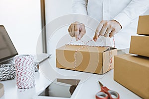 Young asian teenage product owners are packing small business packaging products in boxes prepared for shipping