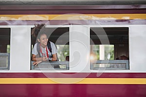 Young asian travel by train sticking her head out of the train, Happy smiling woman female girl looks out from train