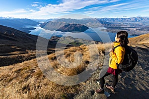 Young asian traveler backpack hiking on Roys peak track, Wanaka, South Island, New Zealand