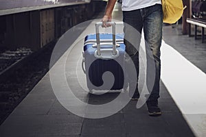 Young asian traveler with backpack in the railway, Man traveler tourist walking with luggage at train station. Active and travel l