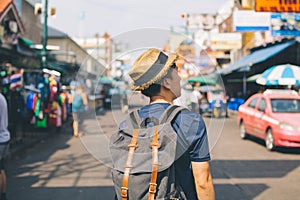 Young Asian traveling backpacker in Khaosan Road outdoor market