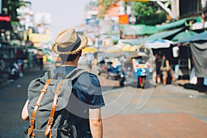 Young Asian traveling backpacker in Khaosan Road outdoor market