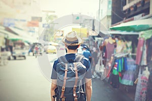 Young Asian traveling backpacker in Khaosan Road outdoor market