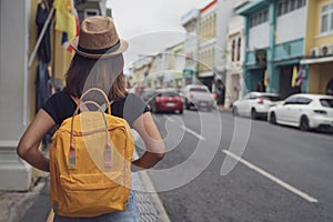 Young Asian traveling backpacker in Khaosan Road outdoor market in Bangkok, Thailand, Tourist, Travel and backpack concept. photo